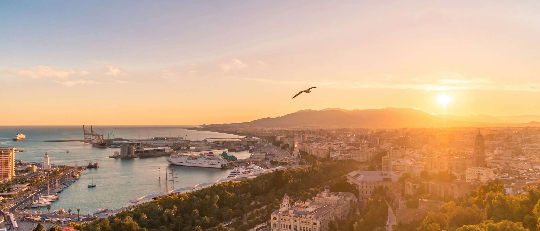 Málaga al atardecer desde Gibralfaro, con el puerto y el Paseo del Parque